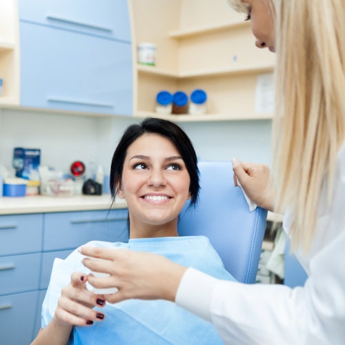 Pacientka s úsměvem komunikuje se zubní lékařkou v ordinaci.